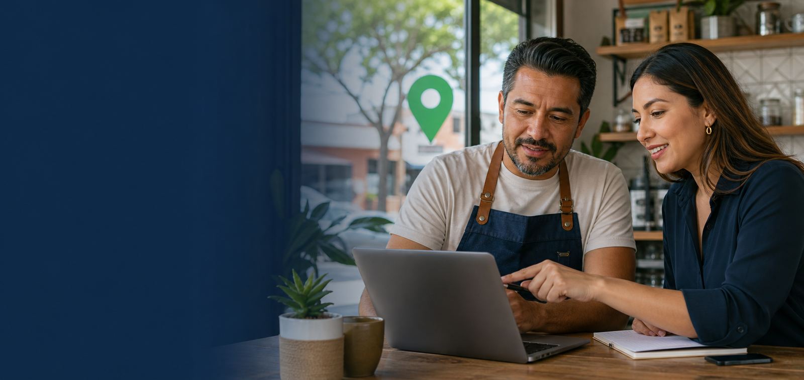 Local business owner reviewing their Google Business Profile on a laptop with a team member